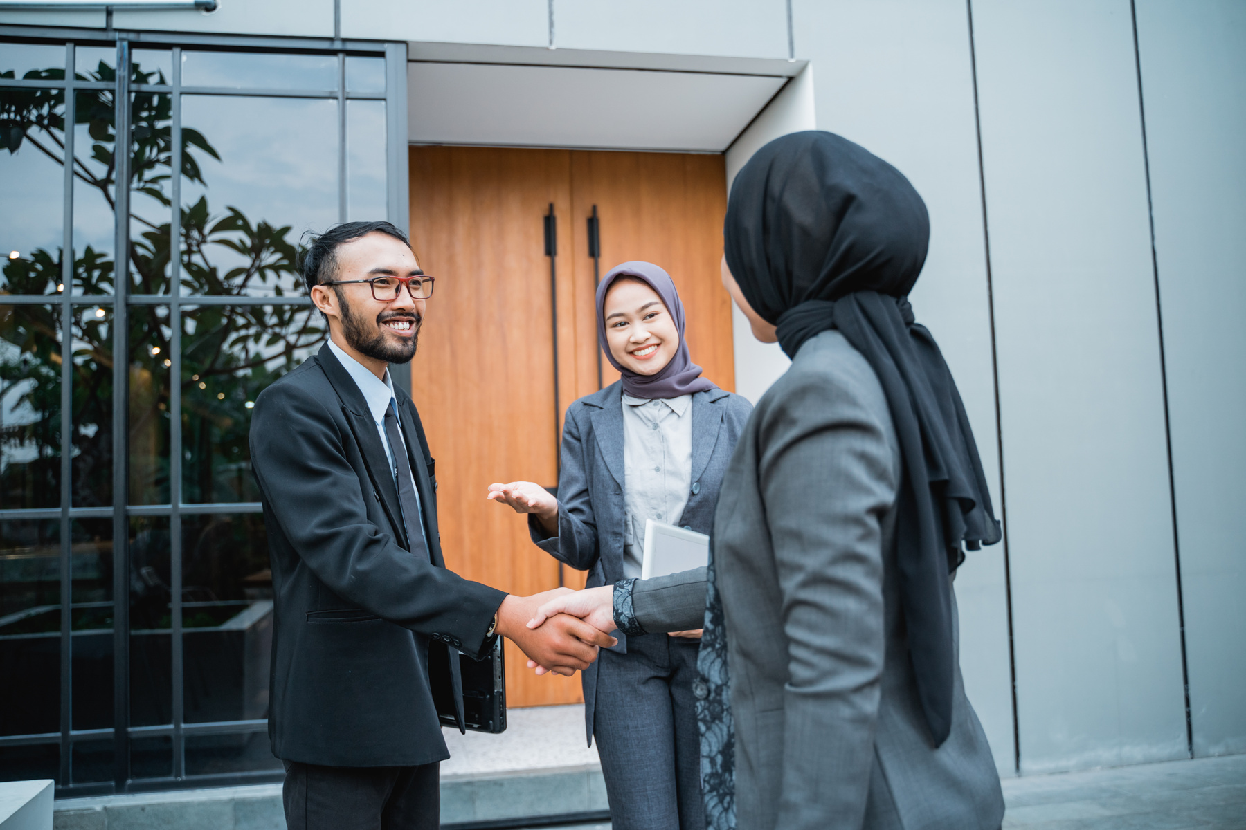 Muslim Businesswoman Shaking Hand with Partner at the Office